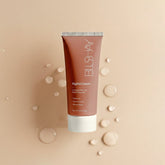 Tube of Blushay Night Cream on a beige background with water droplets